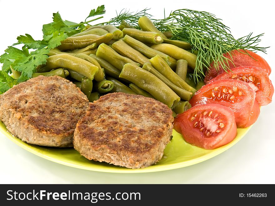 Meat rissoles and vegetables on plate