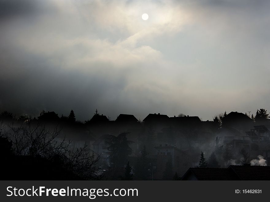 A dark foggy winter noon in the suburbs. A dark foggy winter noon in the suburbs