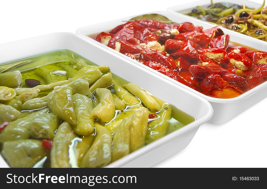 Food containers with peppers in oil, traditional mediterranean recipe. Food containers with peppers in oil, traditional mediterranean recipe.