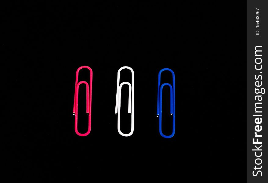 Trio of red, white and blue paper clips.