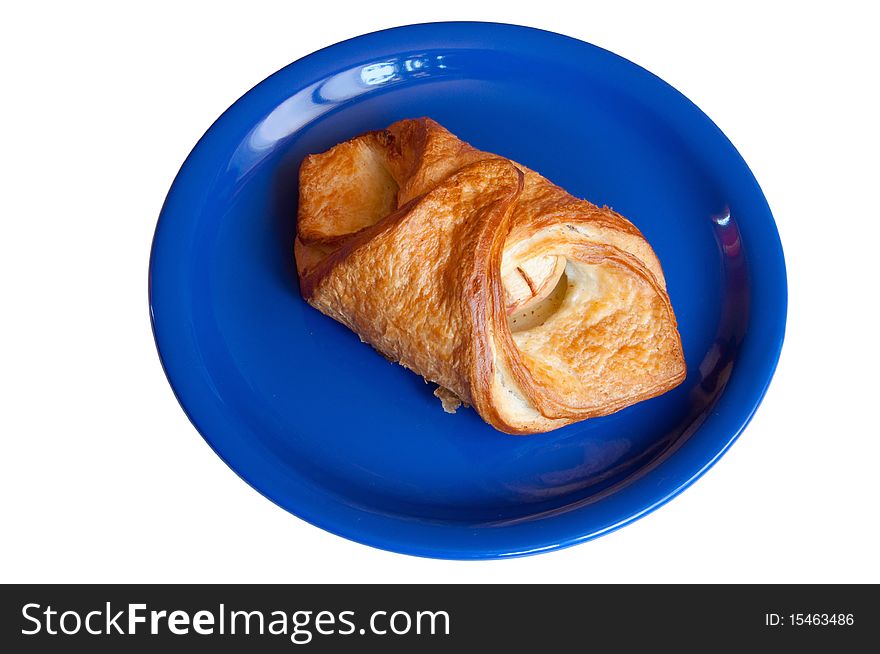 Croissant with apples on a blue plate insulation. Croissant with apples on a blue plate insulation