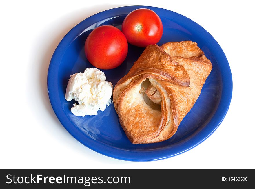 Croissant, cream cheese and tomatoes on the plate insulation. Croissant, cream cheese and tomatoes on the plate insulation