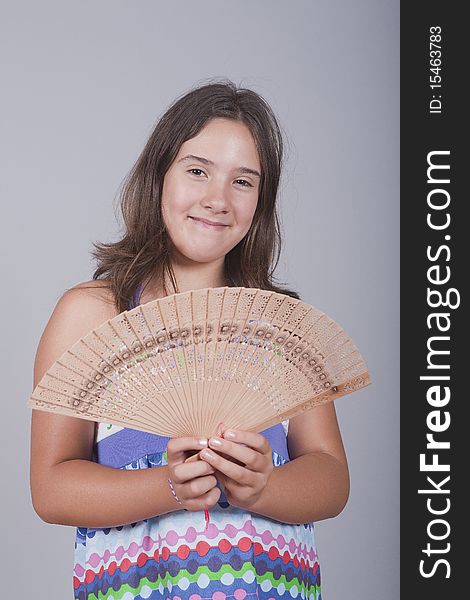 Girl with fan on her hand and smiling