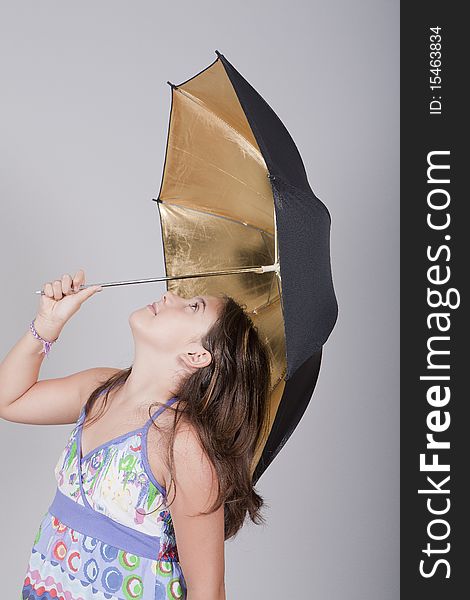 Young girl playing with an umbrella