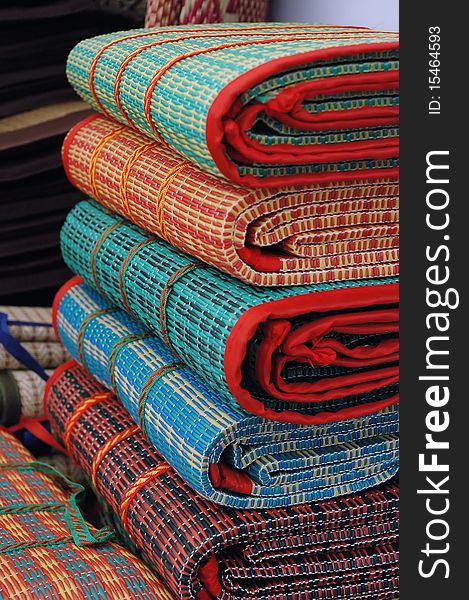 Multi-colored mats sold in the market. Multi-colored mats sold in the market