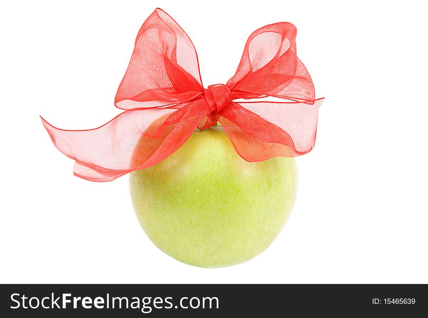 Green apple with a red ribbon on white background. Green apple with a red ribbon on white background
