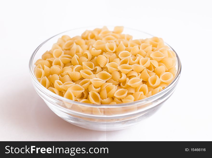 Cup with raw macaroni on isolated background