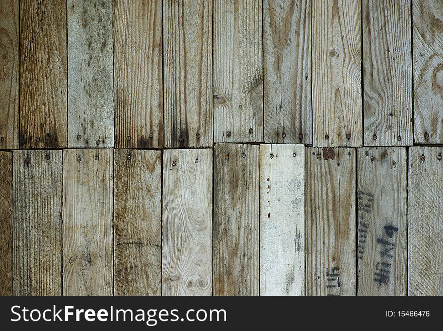 Background, a wall knocked together from wooden planks