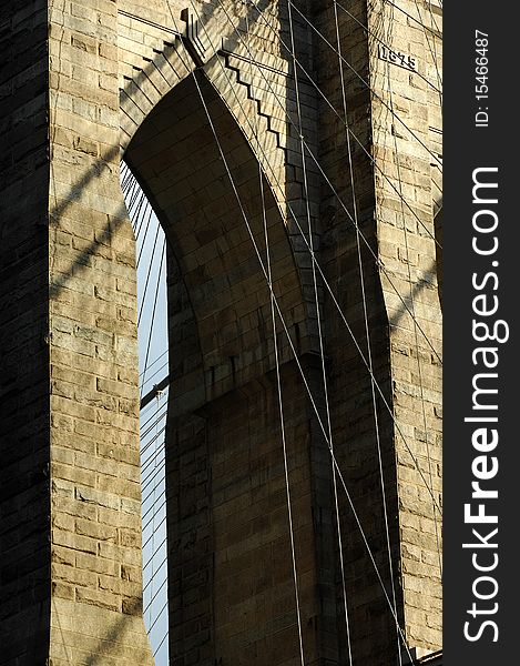 Brooklyn Bridge, New York City on a bright sunny day with patchy clouds.