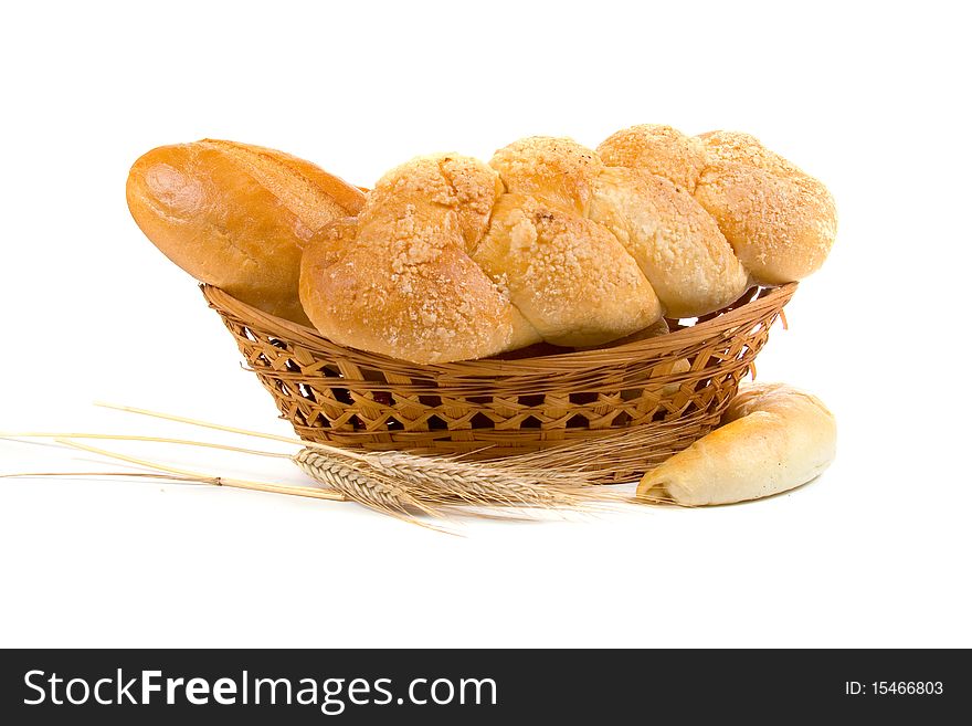 Fresh bread with ears of wheat  on a white background
