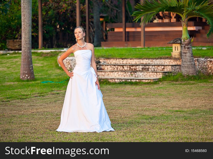 Beautiful young bride in dress outdoors