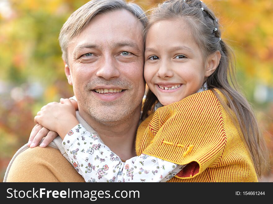 Portrait of father and cute daughter having fun outdoors