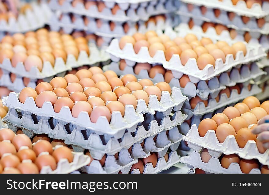 A lot of eggs in the cardboard boxes.