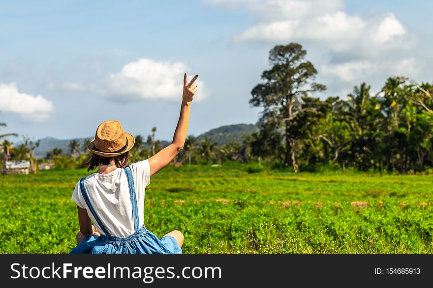 Tropical Portrait Of Young Happy Woman With Straw Hat On A Road With Coconut Palms And Tropical Trees. Bali Island.