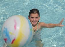 Girl Playing Ball In Pool Royalty Free Stock Photos