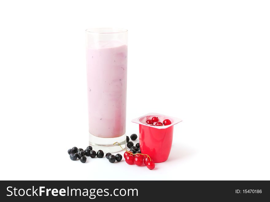 Berry yogurts in a glass and plastic package with blueberries and red currant. Berry yogurts in a glass and plastic package with blueberries and red currant