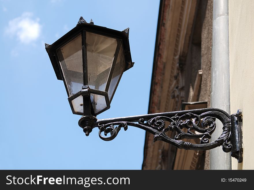 Street Lamp on a high metal lamppost with blue sky background