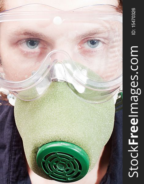 Man closeup in a respirator and safety glasses. Man closeup in a respirator and safety glasses