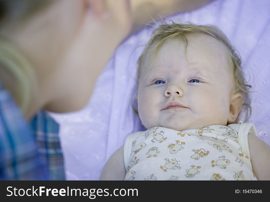 Mother looking at her baby - shot outdoors. Mother looking at her baby - shot outdoors