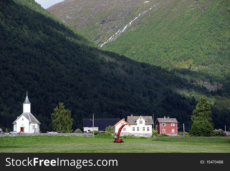 The small farming village of Loen beneath mountains in the Nordfjord area of Norway. The small farming village of Loen beneath mountains in the Nordfjord area of Norway