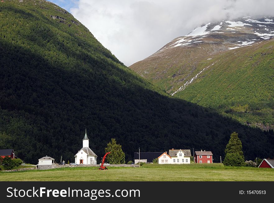 The small farming village of Loen beneath mountains in the Nordfjord area of Norway. The small farming village of Loen beneath mountains in the Nordfjord area of Norway