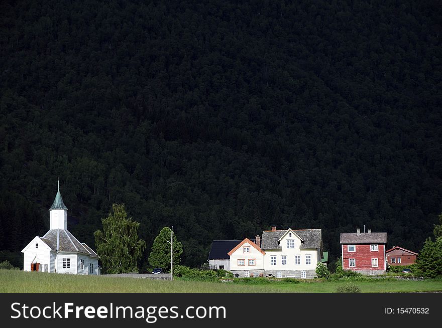 The small farming village of Loen beneath mountains in the Nordfjord area of Norway. The small farming village of Loen beneath mountains in the Nordfjord area of Norway