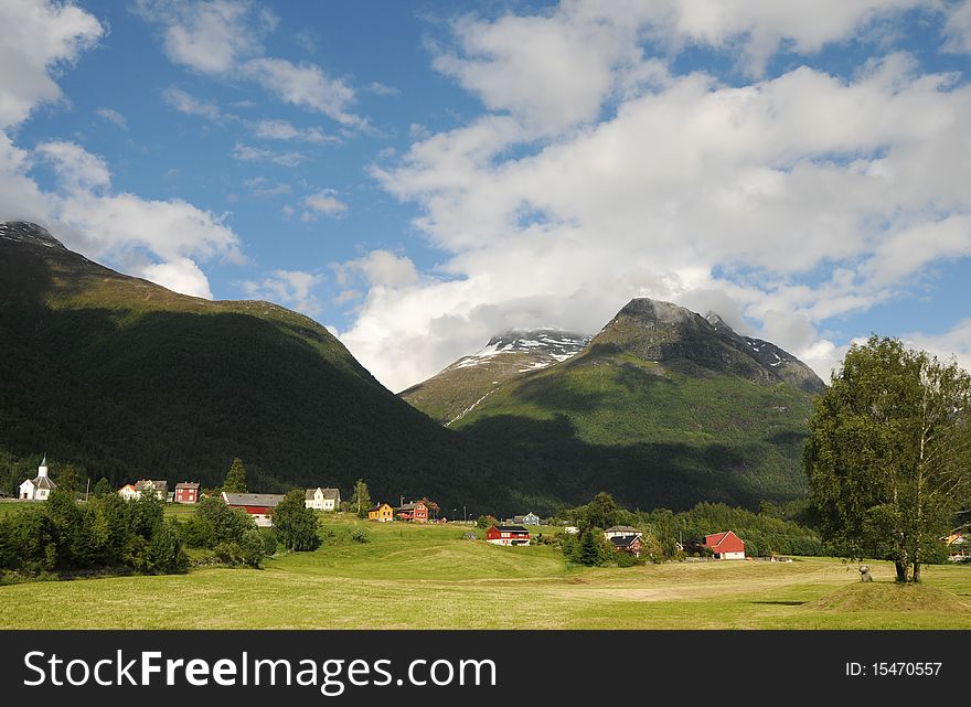 The small farming village of Loen beneath mountains in the Nordfjord area of Norway. The small farming village of Loen beneath mountains in the Nordfjord area of Norway