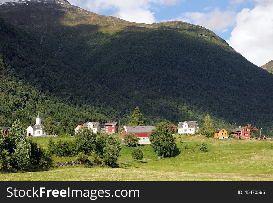 The small farming village of Loen beneath mountains in the Nordfjord area of Norway. The small farming village of Loen beneath mountains in the Nordfjord area of Norway