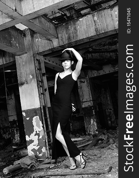 Black and white photo with elegant caucasian young woman performing contemporary dance in devastated building. Black and white photo with elegant caucasian young woman performing contemporary dance in devastated building