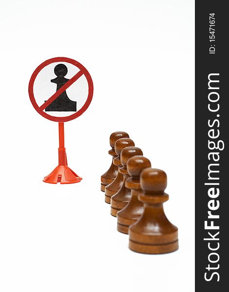 A row of pawns stay in front of prohibit sign. A row of pawns stay in front of prohibit sign