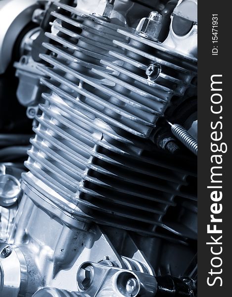 Air cooled motorcycle engine detail with a blue tint