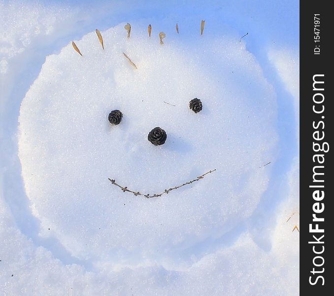 Smiling face hand-made snow picture. Smiling face hand-made snow picture