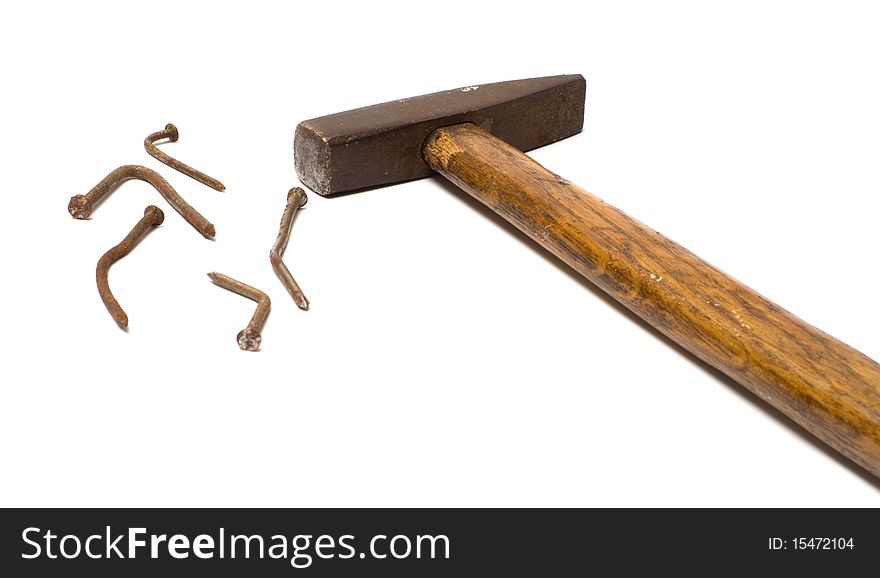 The old hammer and rusty nails bent on a white background. The old hammer and rusty nails bent on a white background.