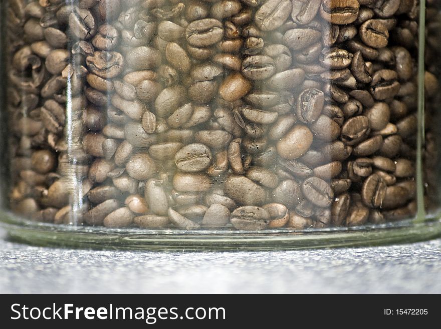 Roasted coffee beans in a glass