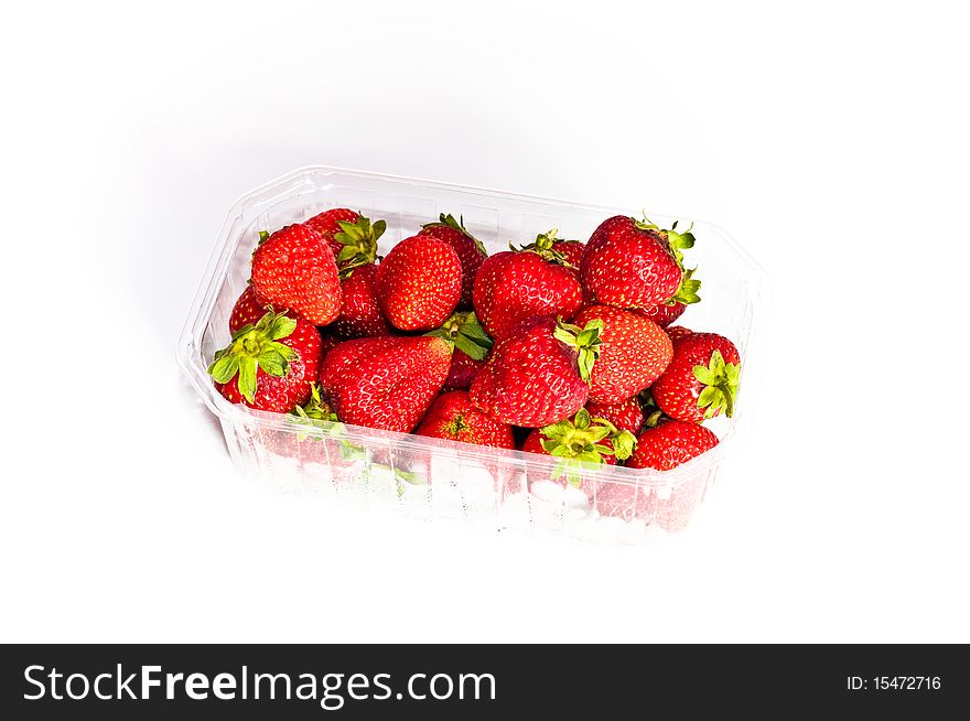 Strawberries isolated on white background in transparent, bright box. Strawberries isolated on white background in transparent, bright box