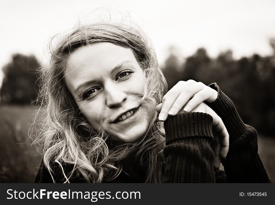 Smiling girl sitting in meadow
