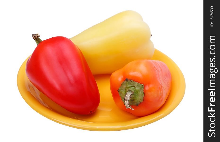 Fresh Sweet peppers on yellow plate. White background.