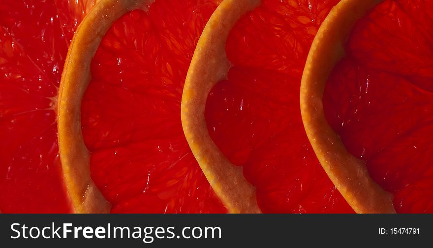 Macro shot of sliced grapefruit, horizontal edge. Macro shot of sliced grapefruit, horizontal edge