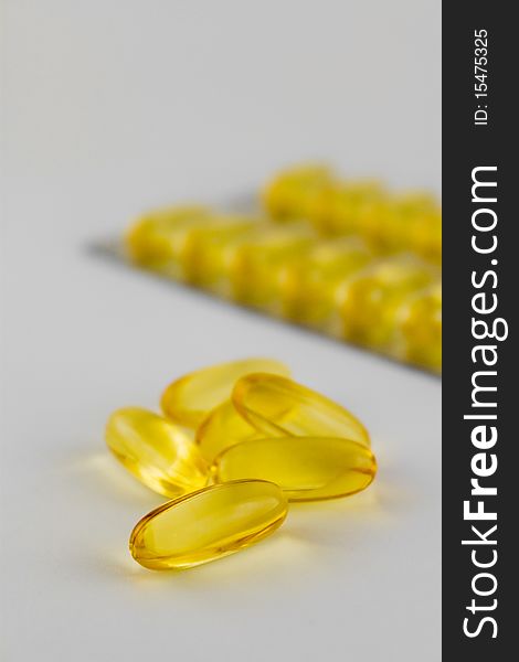 Bunch of yellow gel pills and blister with pills