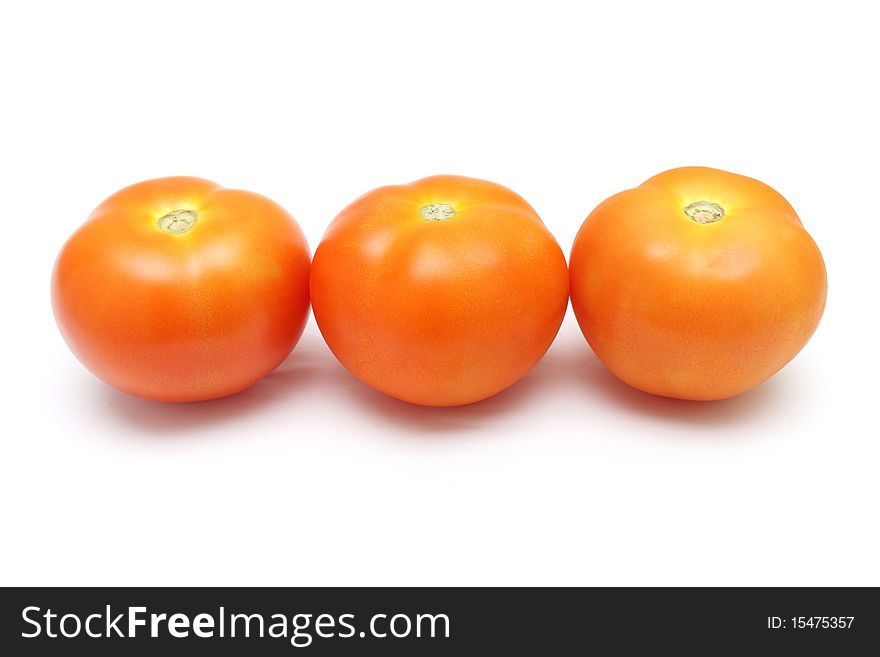 Close up of three tomatoes isolated on white background.