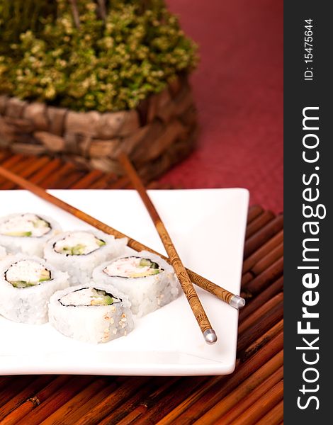 California rolls with chopsticks on a plate