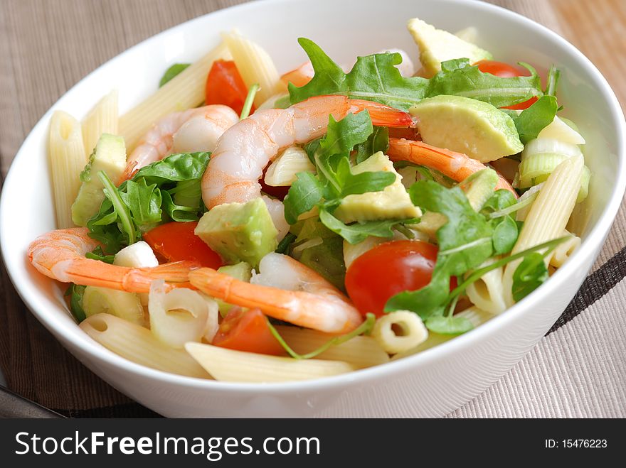 Prawn and avocado pasta salad in a bowl. Prawn and avocado pasta salad in a bowl