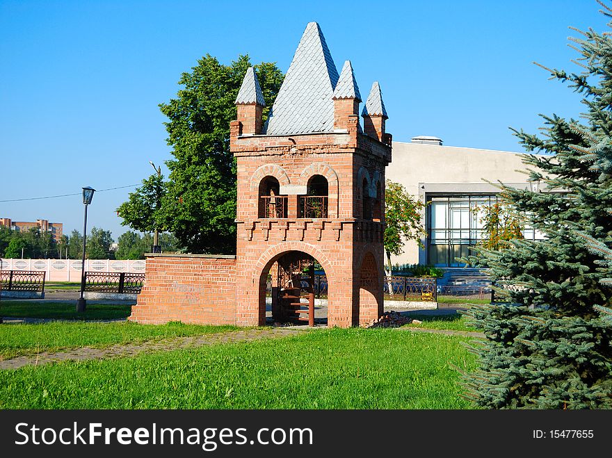 Tower from a red brick on a lawn in park