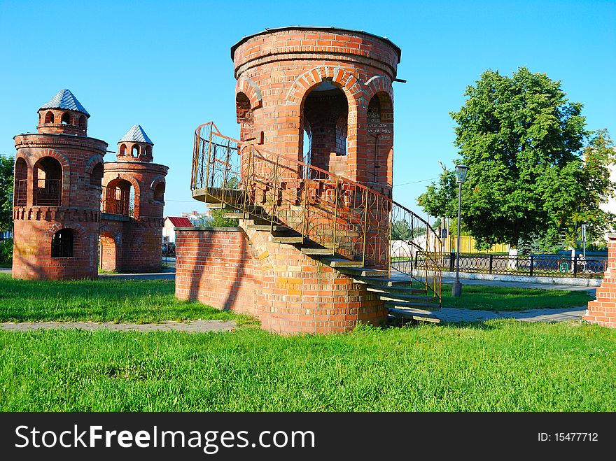 Tower from a red brick on a lawn in park