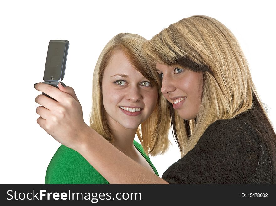 Two pretty womens reading SMS on mobile phone isolated on white background. Two pretty womens reading SMS on mobile phone isolated on white background