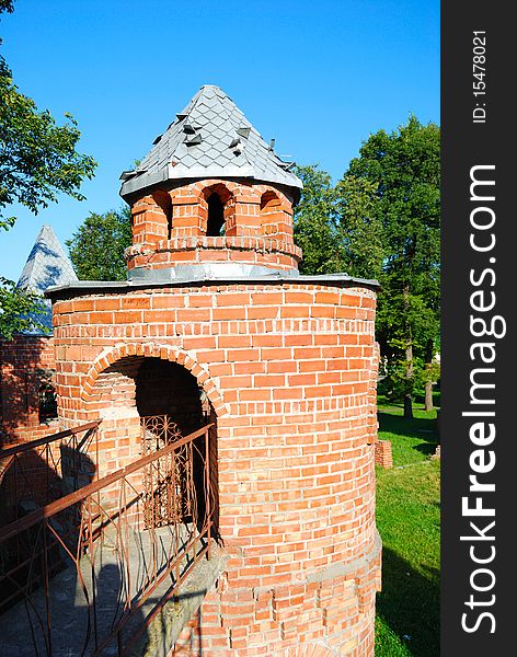 Tower from a red brick on a lawn in park