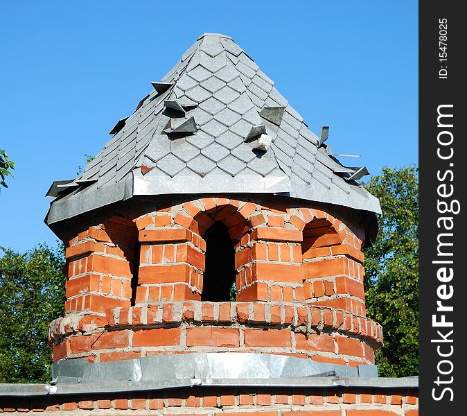 Tower from a red brick on a lawn in park