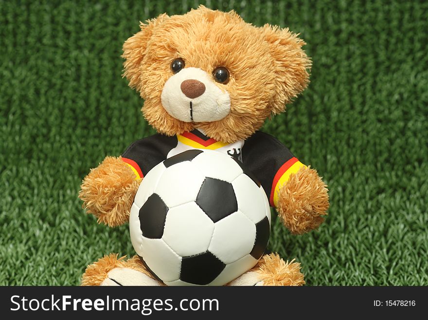 Teddy bear with football shirt on lawn background. Teddy bear with football shirt on lawn background