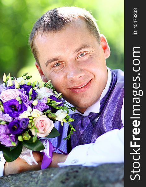 Portrait of the happy man in summer park