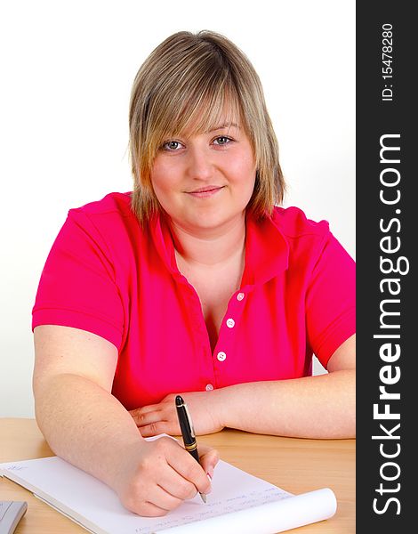 Young female student is writing on white background